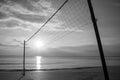 Silhouette Volleyball net on sand beach with beautiful sunset in twilight time. Royalty Free Stock Photo