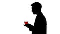 Silhouette of waiter bringing cup of freshly brewed tea to customer, service