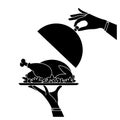 Silhouette waiter hand holding silver serving tray with baked bird and cloche Royalty Free Stock Photo