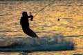 Silhouette of a wakeboarder at sunset.