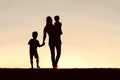 Silhouette of Walking Mother and Young Children Holding Hands at Royalty Free Stock Photo