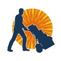 Silhouette of a warehouse worker push a lori chart or hand truck tool transporting boxes. Royalty Free Stock Photo