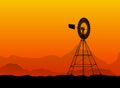 Silhouette of a water pumping windmill at the desert Royalty Free Stock Photo
