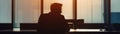 Silhouette of a weary businessman, late office light, desk solitude  , minimalist Royalty Free Stock Photo