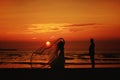 silhouette of a wedding couple on the beach at orange sunset Royalty Free Stock Photo