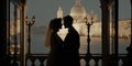 Silhouette of wedding couple on their honeymoon hugging kissing on a terrace in the evening with Venice background