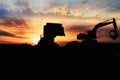 Silhouette Wheel loader and Crawler excavator are digging the soil in the construction site. Royalty Free Stock Photo