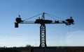 Silhouette of white stork nesting over old construction crane Royalty Free Stock Photo