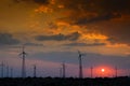 Silhouette of wind mills, twilight with a setting sun and cloudy sky in background, Rajasthan, India Royalty Free Stock Photo