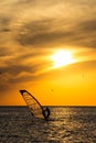 Silhouette of a wind-surfer on waves sunset Royalty Free Stock Photo