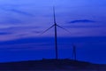 Silhouette wind turbine farm over moutain with twilight sky and Royalty Free Stock Photo