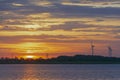 silhouette of wind turbine generating electricity on sunset