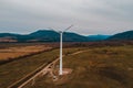 Silhouette of a wind turbine on a mountain at sunset, a windmill in the Ukrainian Carpathians, a windmill close up, top view Royalty Free Stock Photo