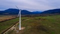 Silhouette of a wind turbine on a mountain at sunset, a windmill in the Ukrainian Carpathians, a windmill close up, top view Royalty Free Stock Photo