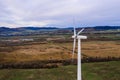 Silhouette of a wind turbine on a mountain at sunset, a windmill in the Ukrainian Carpathians, a windmill close up, top view Royalty Free Stock Photo