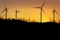 silhouette wind turbines generating electricity on sunset