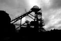 Silhouette of winding gear at mining pit head. Royalty Free Stock Photo