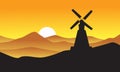 Silhouette of windmill with mountain backgrounds
