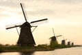 Silhouette of windmills at amazing foggy sunrise in Kinderdijk Netherlands. Royalty Free Stock Photo