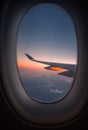 Silhouette wing of an airplane at sunrise view through the window Royalty Free Stock Photo