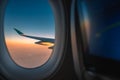 Silhouette wing of an airplane at sunrise view through the window Royalty Free Stock Photo