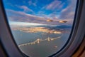 Silhouette wing of an airplane at sunset view through the window Royalty Free Stock Photo