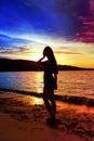 Silhouette of the woman against a sunset at ocean Royalty Free Stock Photo