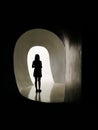 Silhouette of woman alone in front of light door, moving mental illness from the shadows into the light