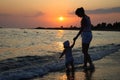 Silhouette of woman and baby on sunset Royalty Free Stock Photo