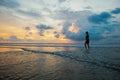 Silhouette of a woman on the background of beautiful sunset on the Kuta beach