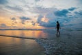 Silhouette of a woman on the background of great sunset on the Kuta beach