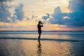 Silhouette of a woman on the background of sunset on the Kuta beach