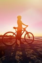 Silhouette of woman biking at sunset Royalty Free Stock Photo