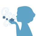 Silhouette of woman blowing snowflakes