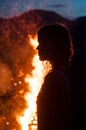 Silhouette of woman with bonfire