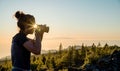Silhouette of woman with camera. Woman takes photo of La Gomera Island in the rays of the setting sun. Tenerife Island Royalty Free Stock Photo