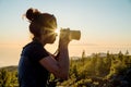 Silhouette of woman with camera. Woman takes photo of La Gomera Island in the rays of the setting sun. Tenerife Island Royalty Free Stock Photo