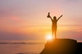 Silhouette of Woman Celebration Success Happiness on a Stone Evening Sky Sunset at Beach Background, Sport and active life Concept Royalty Free Stock Photo