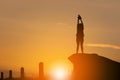 Silhouette of Woman Celebration Success Happiness on a Stone Evening Sky Sunset at Beach Background, Sport and active life Concept Royalty Free Stock Photo