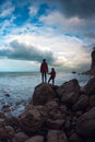 Silhouette of a woman and a child against the sea and sky Royalty Free Stock Photo