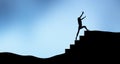 Silhouette of a woman climbing a staircase step