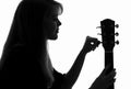 Silhouette of a woman configure a guitar