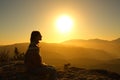 Silhouette of a woman contemplating nature at sunset