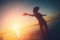 Silhouette of woman dancing in the ocean at sunset Royalty Free Stock Photo