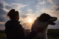 silhouette of woman and dog head at sunset pet teraphy