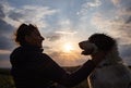 silhouette of woman and dog head at sunset pet teraphy