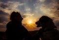 silhouette of woman and dog head at sunset pet teraphy