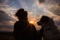 silhouette of woman and dog head at sunset pet teraphy