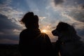 silhouette of woman and dog head at sunset pet teraphy