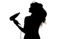 Silhouette of a woman doing a hairstyle with hair dryer, concept of fashion and beauty